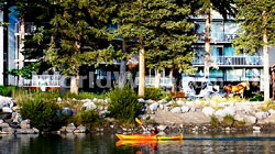 A Tourist Kayaks Down The Bow River in Front of the Bow View Lodge