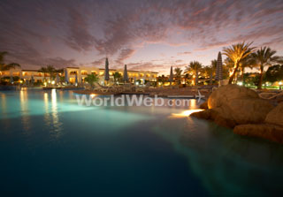 sun setting over a luxury resort
